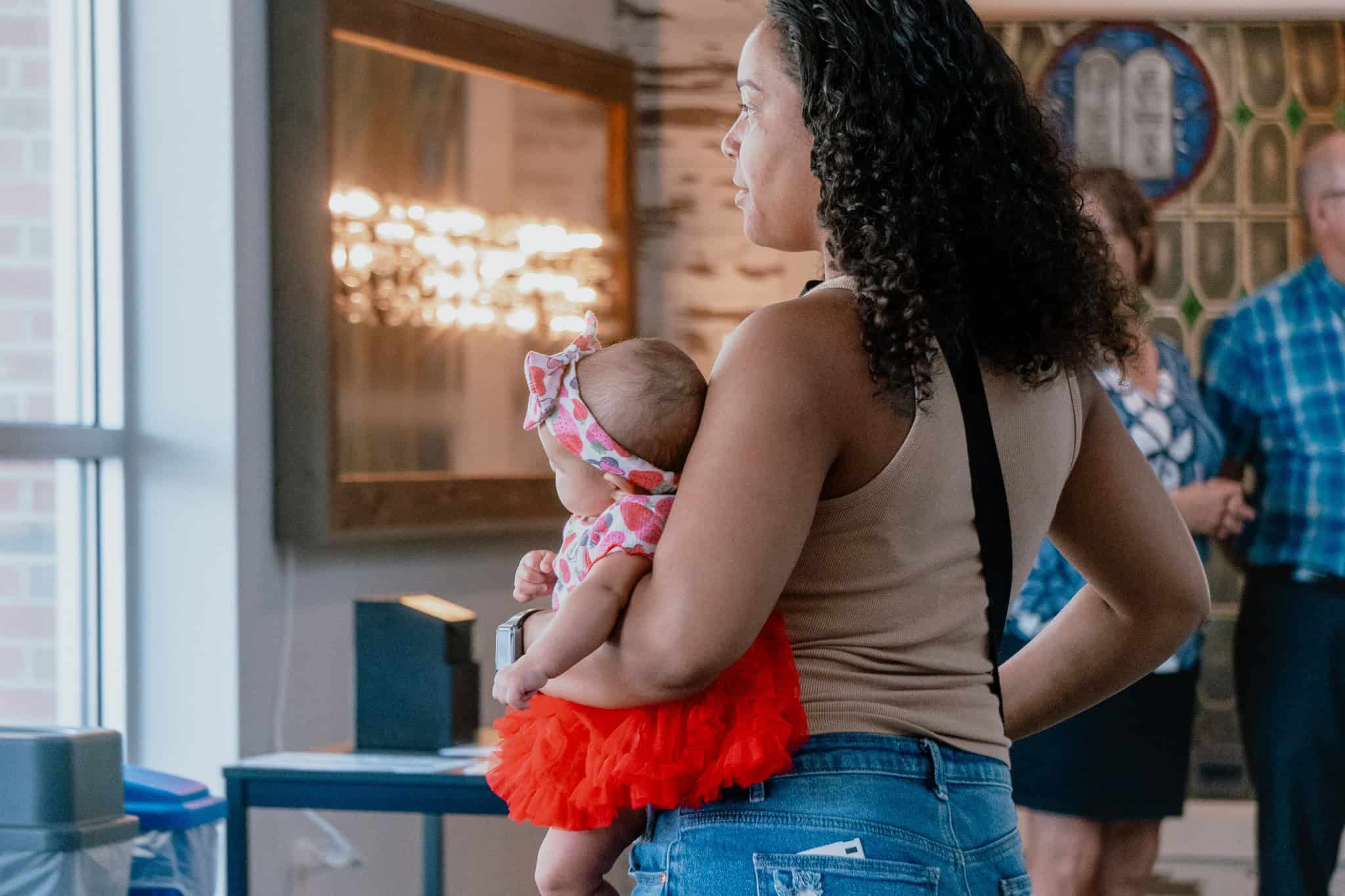 Loving mother holding her baby during church service in Indianapolis.