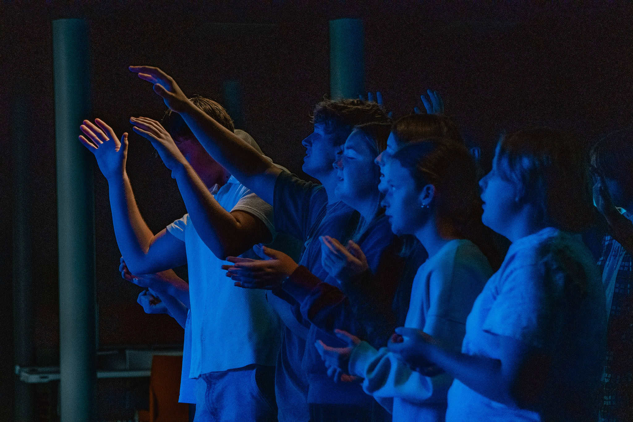 Children praying at church in Indianapolis, vibrant worship scene emphasizing faith and community.