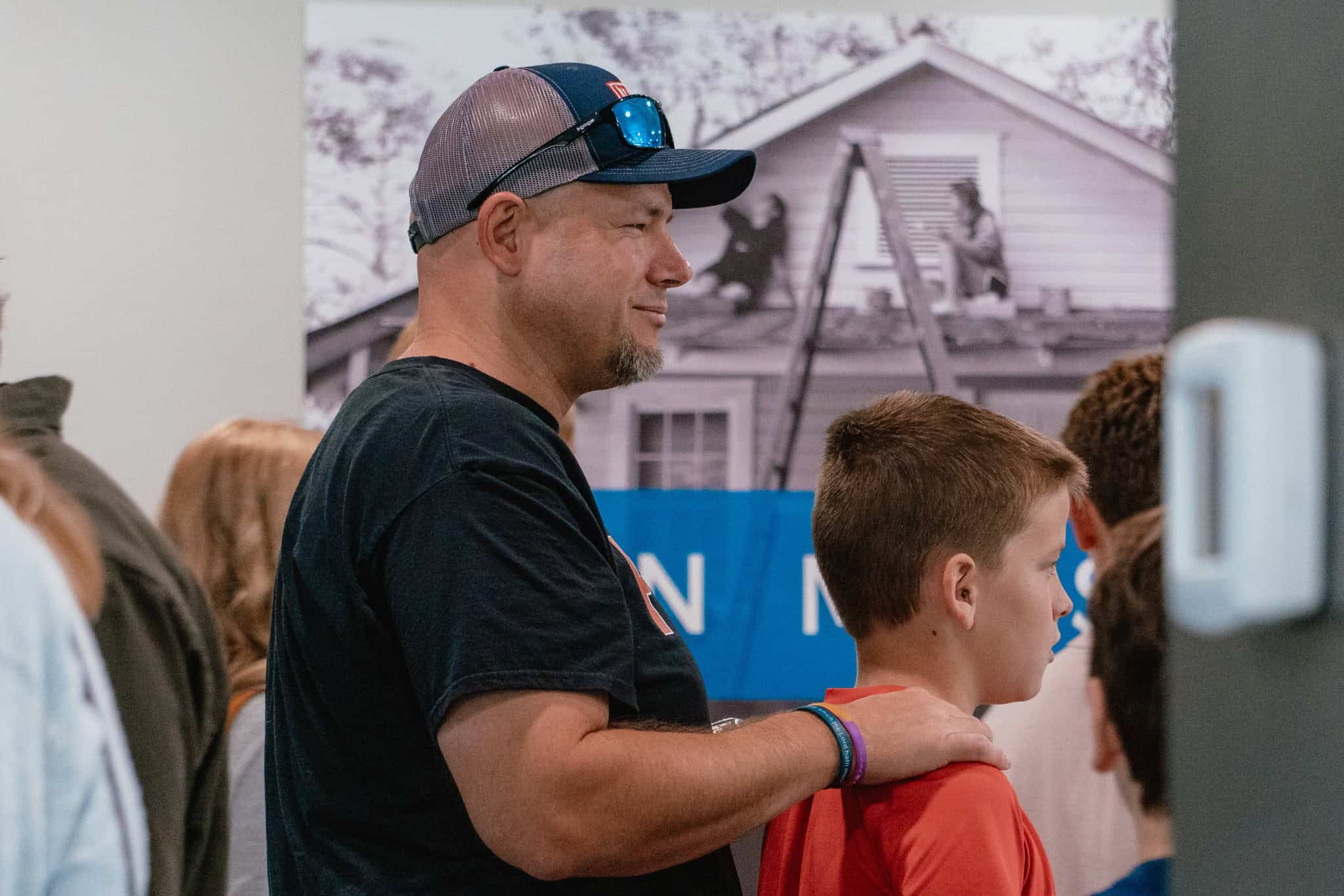 Father and child praying at a church gathering in Indianapolis, fostering faith and community.